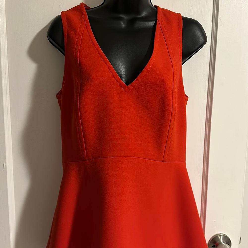 Red sleeveless peplum blouse.